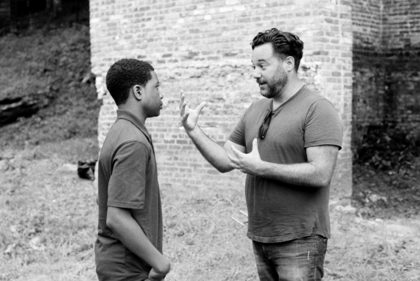 Elijah M. Cooper taking direction from Richard Raymond on the set of "A Million Eyes"