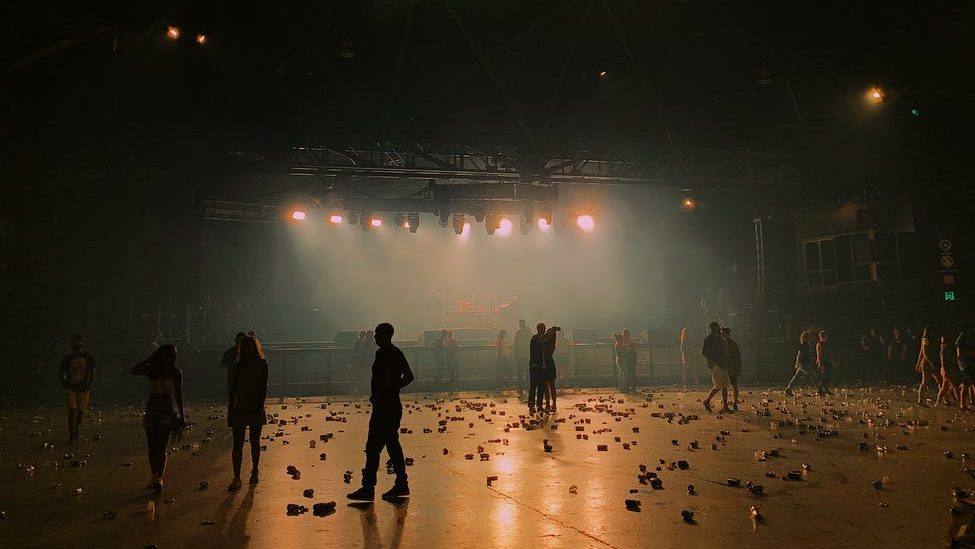 silhouettes of unrecognizable actors giving performance on theater stage